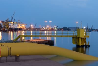 Pipeline an einer Hafenanlage mit Industrieanlagen im Hintergrund